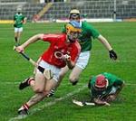 Description: Corks  Darren Sweetnam (Sam Maguires) evades the twin challenges of Limericks Brendan O Connor and David Reidy in the Munster Minor Hurling Championship Round 1 game at Pairc na nGael Limerick&nbsp;|&nbsp;Copyright: George Hatchell